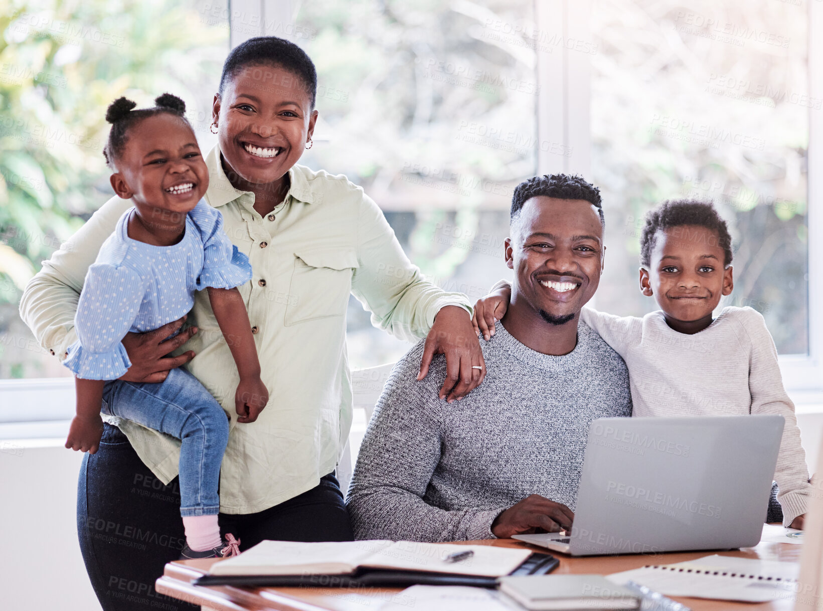 Buy stock photo Shot of a happy young family huddled together at home