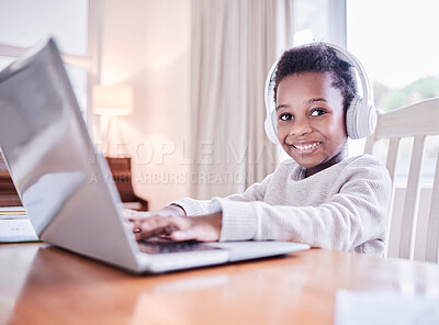 Buy stock photo Shot of a young boy doing his homework on a laptop at home