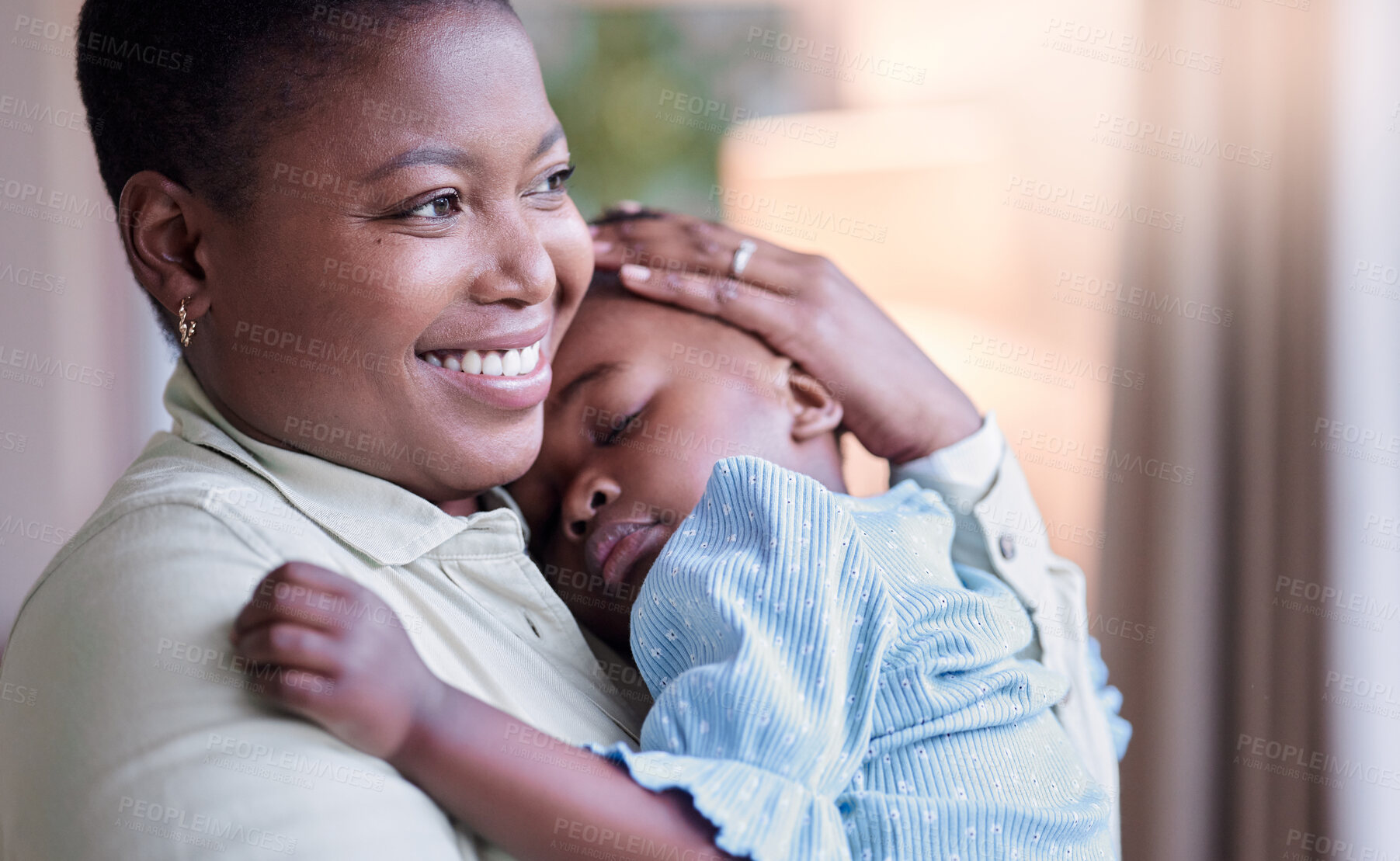 Buy stock photo Shot of a young mother holding her daughter at home