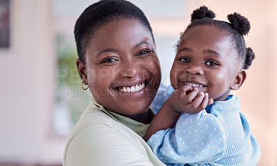 Buy stock photo Shot of a young mother holding her daughter at home