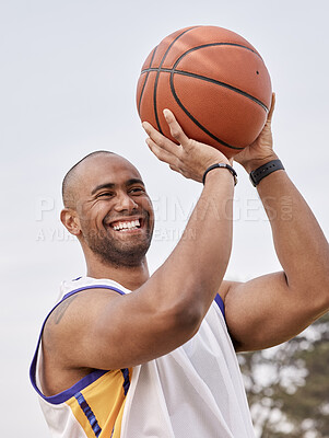 Buy stock photo Shot of a handsome young man playing basketball outside