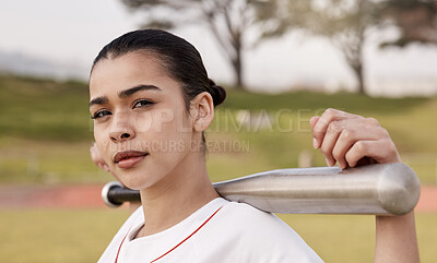 Buy stock photo Shot of an attractive young woman standing alone outside and posing with a baseball bat