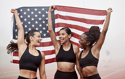 Buy stock photo Shot of female athletes celebrating their win while holding a flag