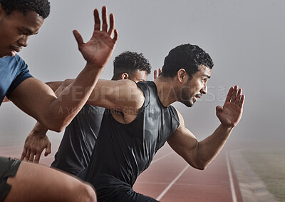 Buy stock photo Shot of a group of male athletes participating in a race