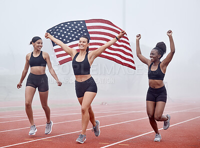 Buy stock photo Shot of female athletes celebrating their win while holding a flag