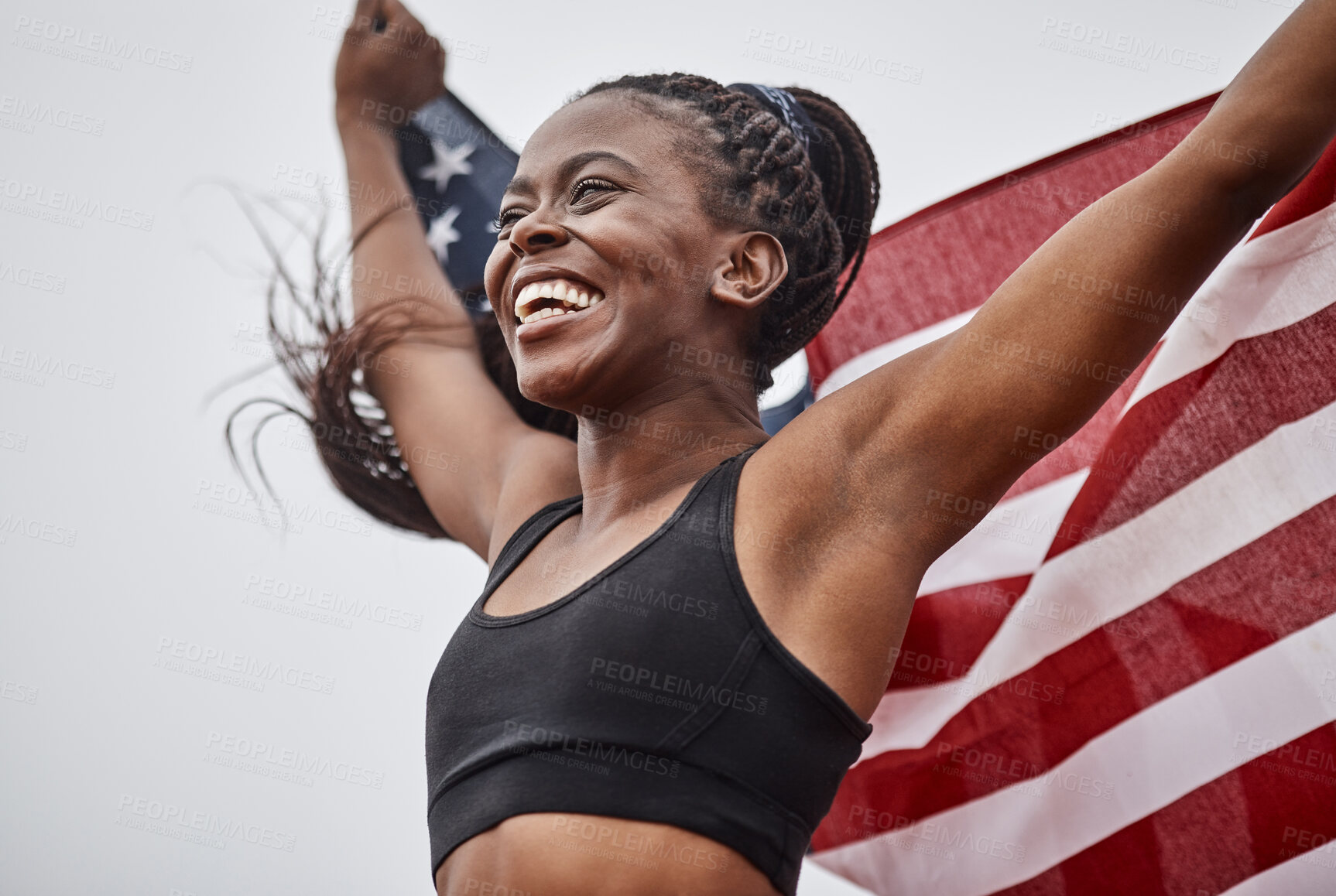 Buy stock photo Shot of a young female athlete holding a flag