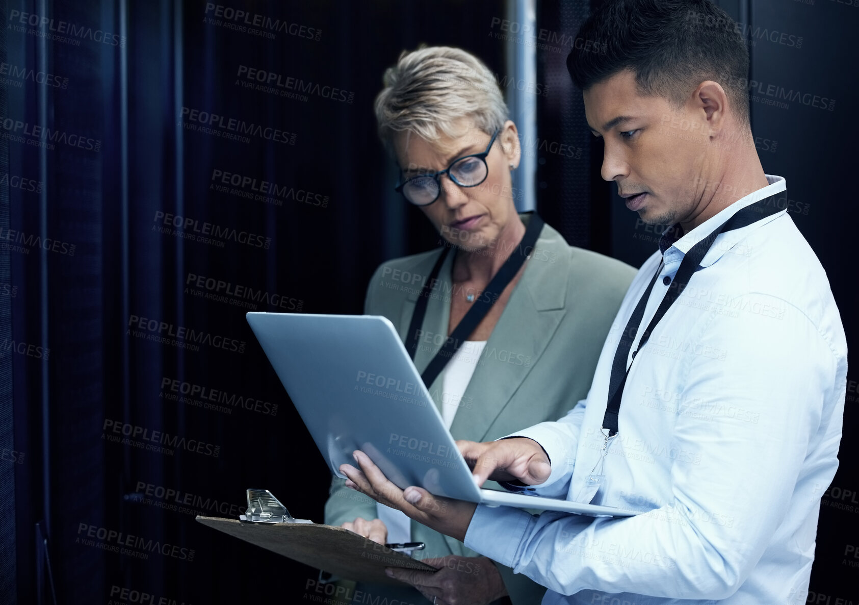 Buy stock photo Data center, people and computer engineer with clipboard, collaboration and programming. Mature woman, analytics and technician with hardware, security or maintenance for system update in server room