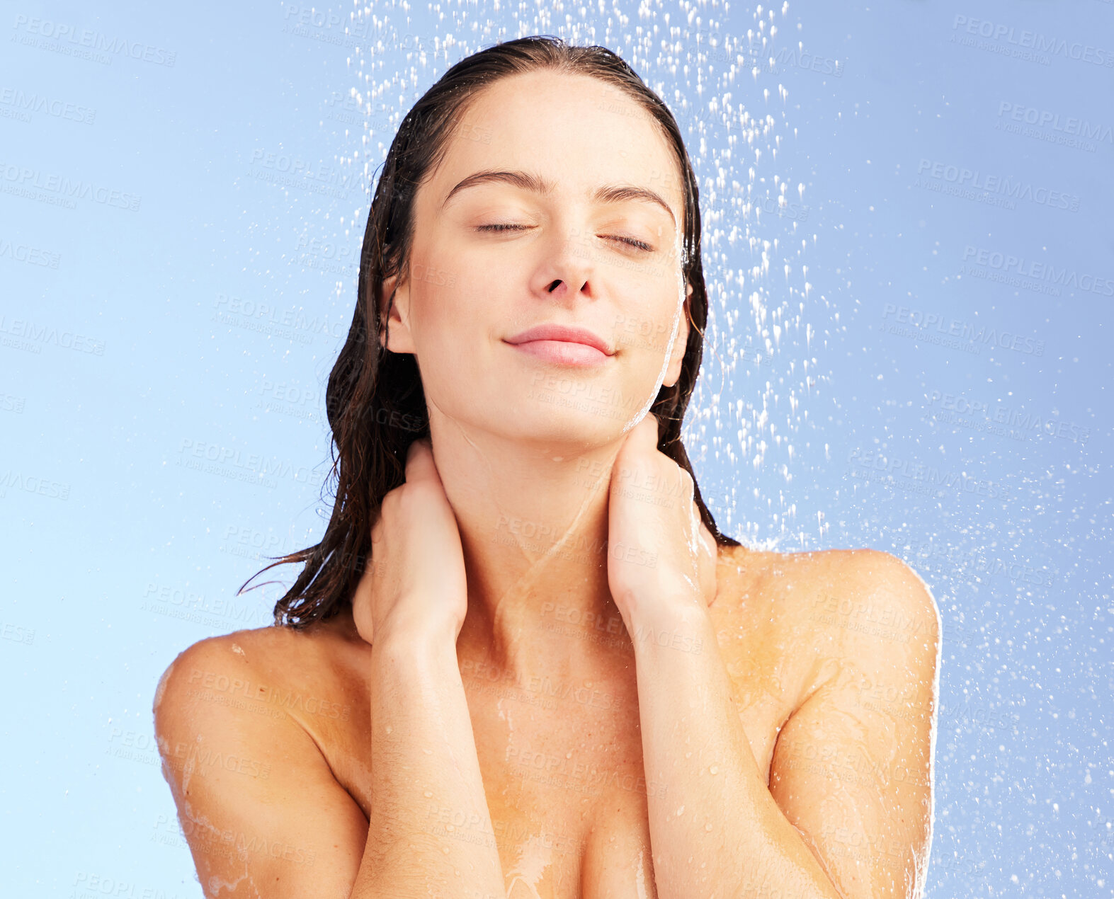 Buy stock photo Shot of a young woman washing her hair in the shower against a blue background