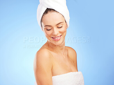 Buy stock photo Shot of a young woman in a towel against a blue background