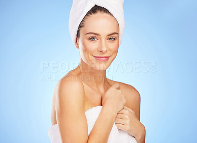 Buy stock photo Shot of a young woman in a towel against a blue background