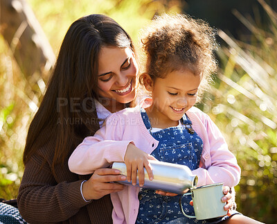 Buy stock photo Cropped shot of an adorable little girl pouring her mother coffee from a flask during their picnic in the park