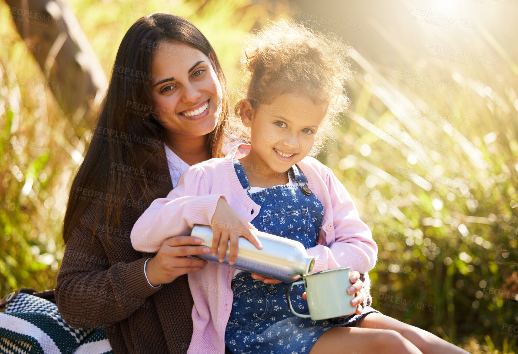 Buy stock photo Mom, child and drink for picnic portrait with coffee flask, summer and bonding together in nature. Mama, young girl and liquid container for cup, love relationship and pour espresso in grass field