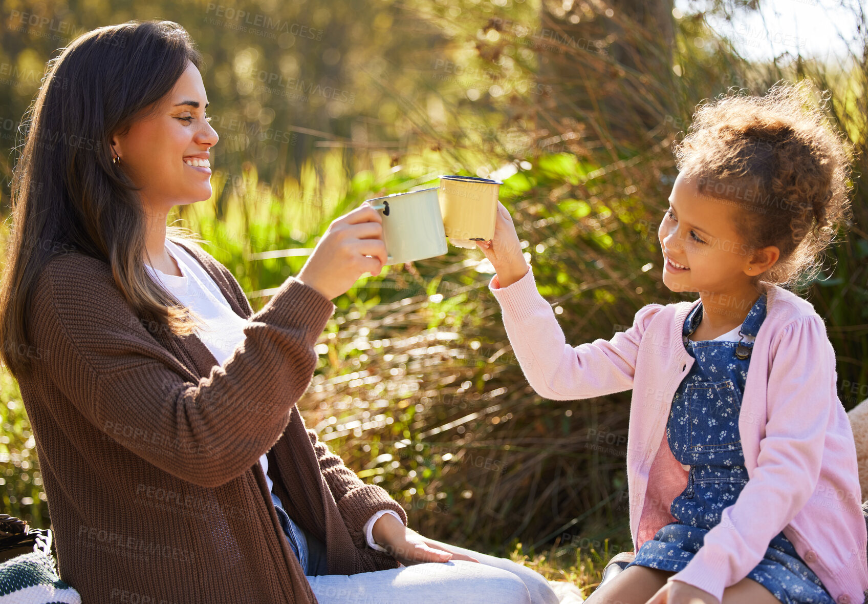 Buy stock photo Mother, child and toast together for outdoor picnic with coffee drink, summer and bonding in nature. Mom, young girl and cheers with espresso cup, love relationship and happy family on grassy field