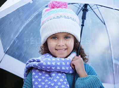 Buy stock photo Shot of an adorable little girl standing alone outside and holding an umbrella