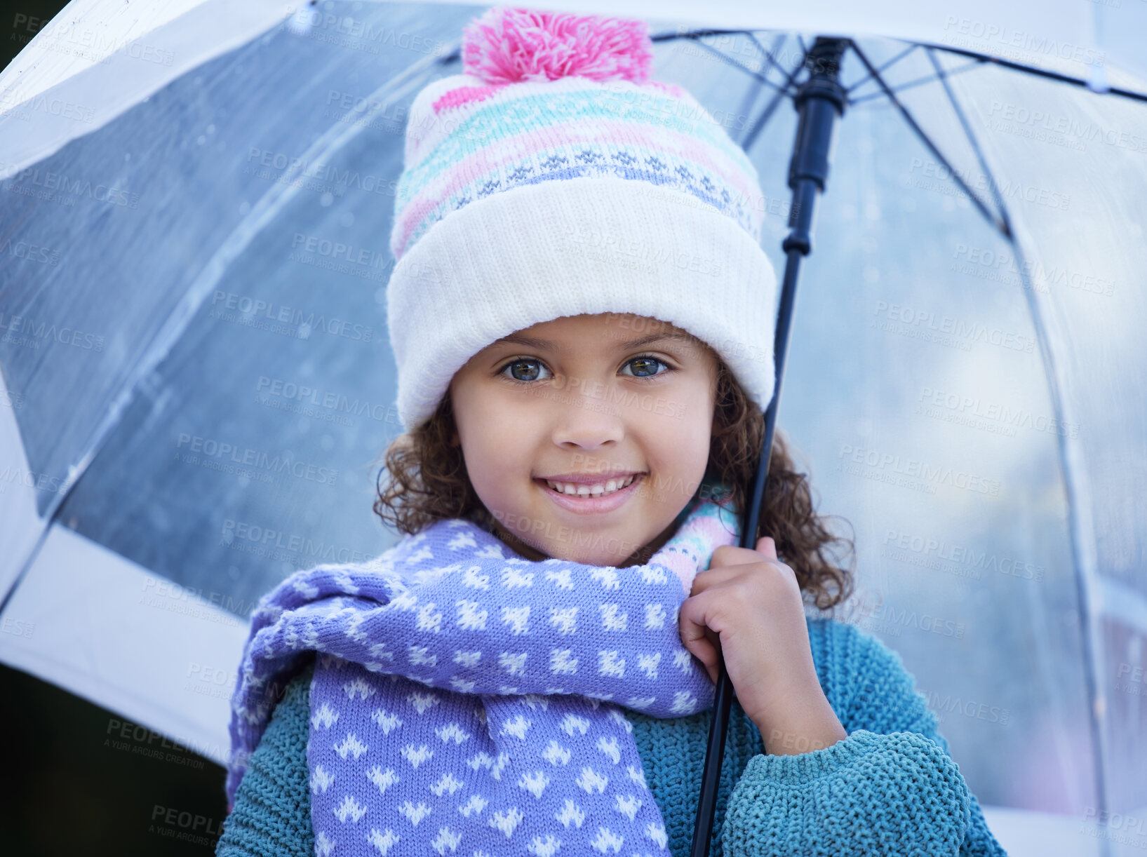 Buy stock photo Shot of an adorable little girl standing alone outside and holding an umbrella