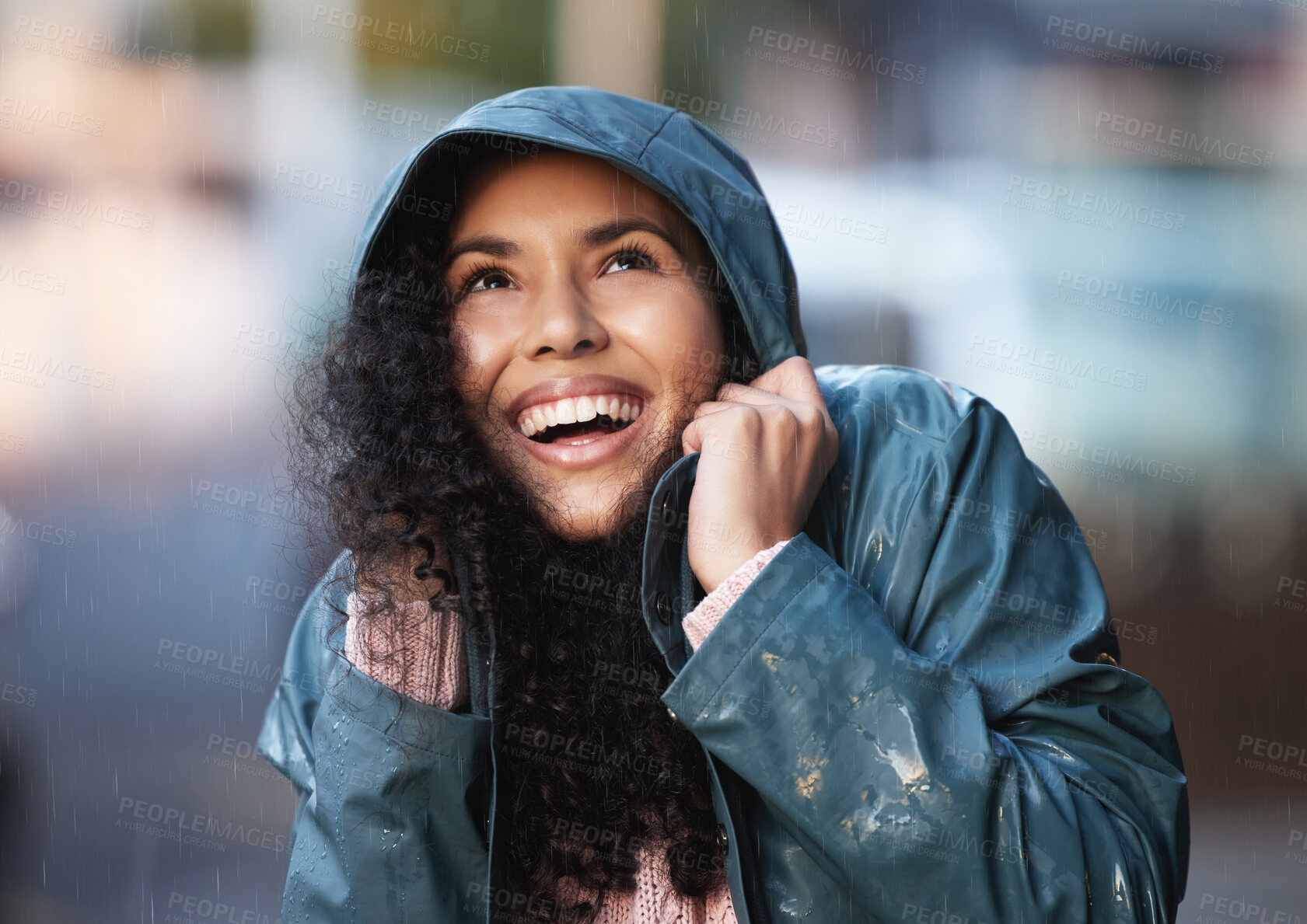 Buy stock photo Shot of a young woman admiring the rain in the city
