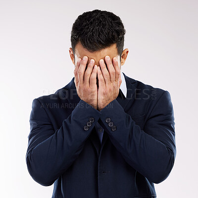 Buy stock photo Studio shot of a young businessman covering his face against a white background
