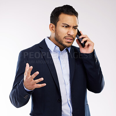 Buy stock photo Studio shot of a young businessman looking angry while talking on a cellphone against a white background