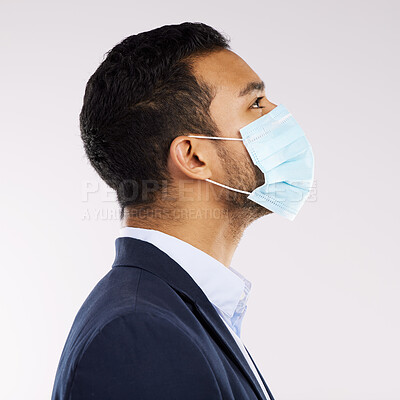 Buy stock photo Studio shot of a young businessman wearing a face mask against a white background
