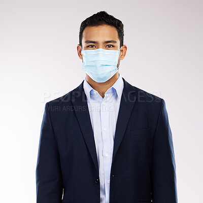 Buy stock photo Studio portrait of a young businessman wearing a face mask against a white background