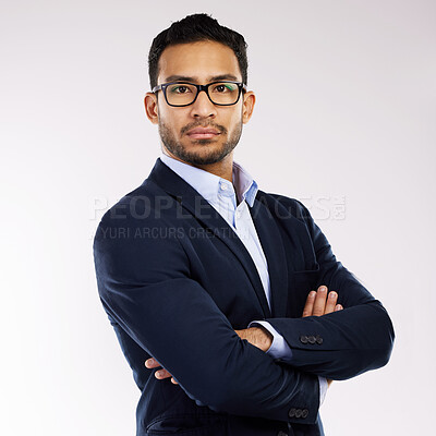 Buy stock photo Studio portrait of a confident young businessman standing with his arms crossed against a white background