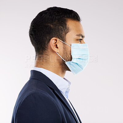 Buy stock photo Studio shot of a young businessman wearing a face mask against a white background