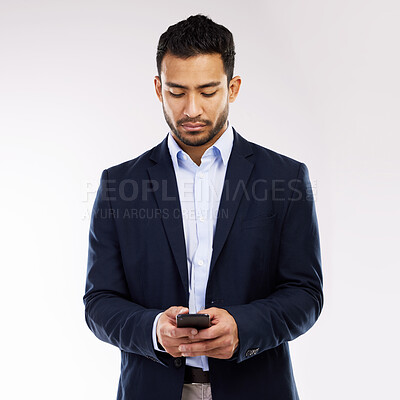 Buy stock photo Studio shot of a young businessman using a cellphone against a white background