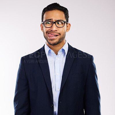 Buy stock photo Shot of a handsome man standing alone against a grey background in the studio and making funny faces