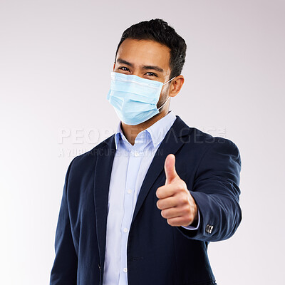 Buy stock photo Studio shot of a young man showing a thumbs up gesture against a white background
