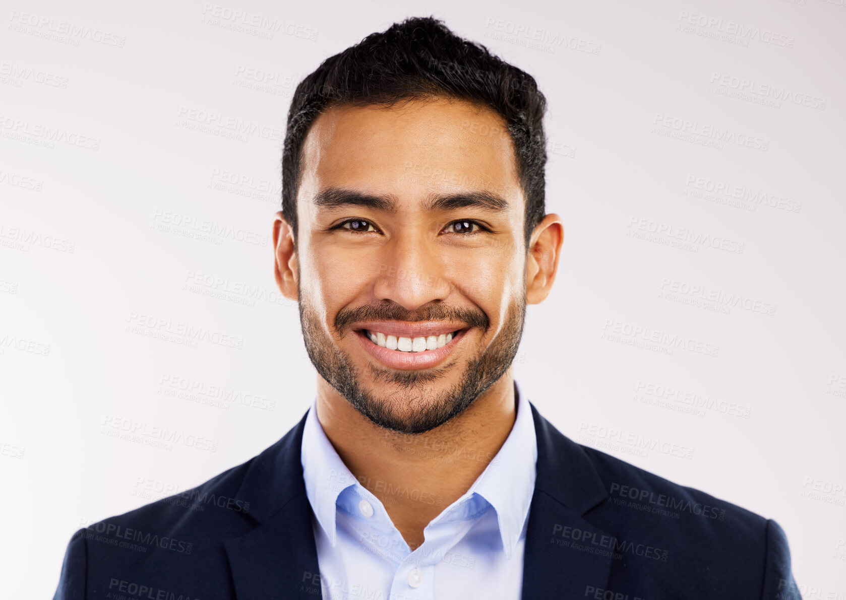 Buy stock photo Studio shot of a handsome and happy young man posing against a grey background