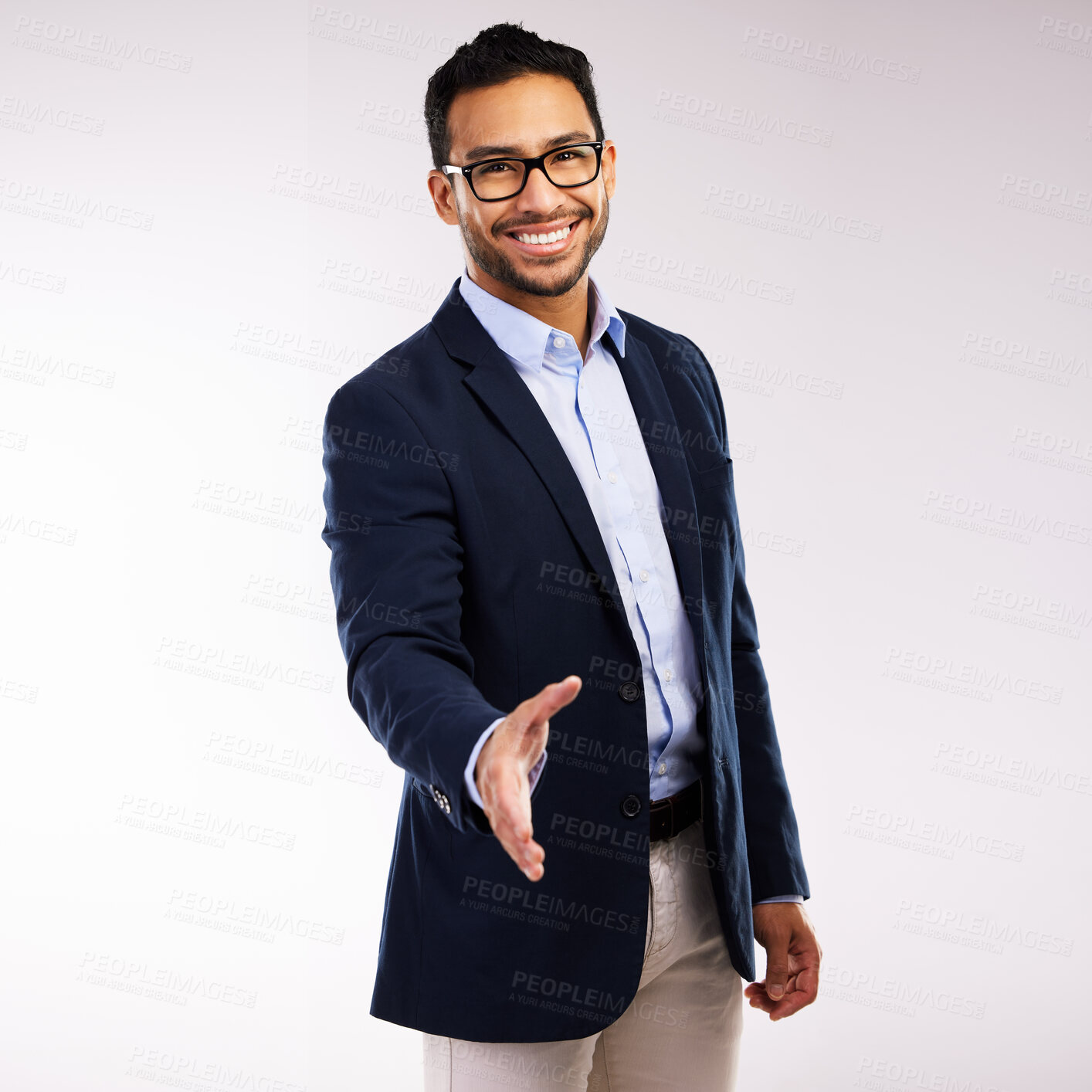 Buy stock photo Studio shot of a handsome young man  extending his arm for a handshake against a grey background