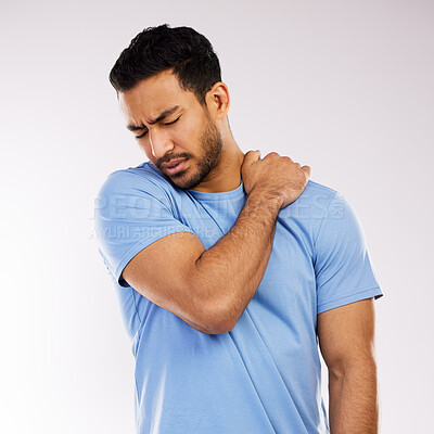 Buy stock photo Studio shot of an young man experiencing some pain against a grey background