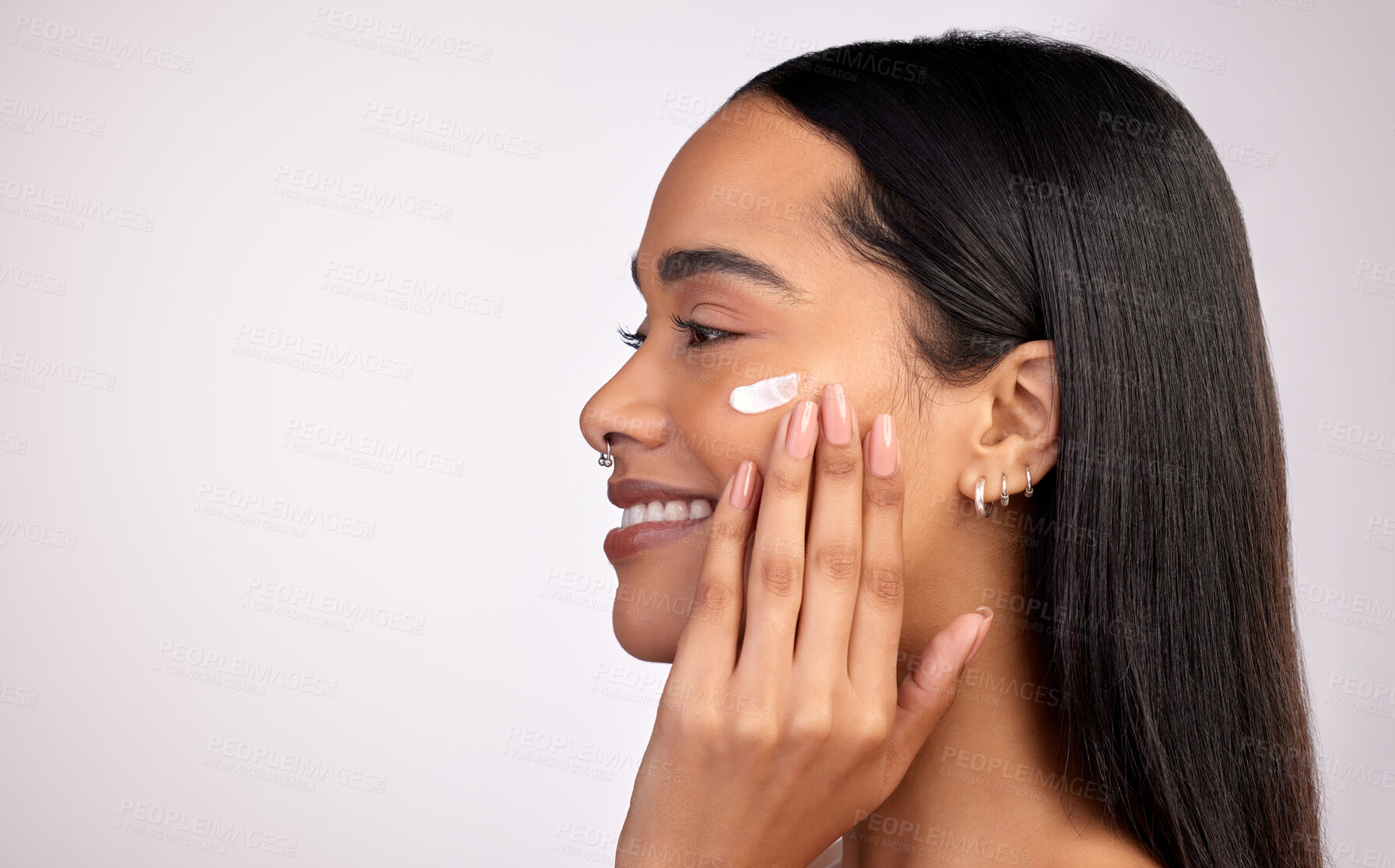 Buy stock photo Happy woman, face and cream on mockup for skincare, beauty or cosmetics against a grey studio background. Female person smiling with lotion, creme or moisturizer for facial treatment on mock up space