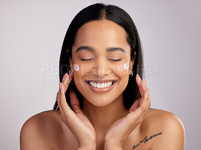 Buy stock photo Happy woman, face and smile with cream for skincare, beauty or cosmetics against a grey studio background. Female person or model smiling for lotion, creme or cosmetic moisturizer or facial treatment
