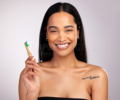Buy stock photo Happy woman, portrait and teeth with toothbrush for dental, cleaning or hygiene against a grey studio background. Face of female person with bamboo tooth brush in clean oral, mouth and gum healthcare