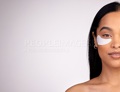 Buy stock photo Woman, portrait and eye patches on mockup for skincare, beauty or dermatology against a grey studio background. Happy female person or model with patch under eyes in healthy wellness on mock up space