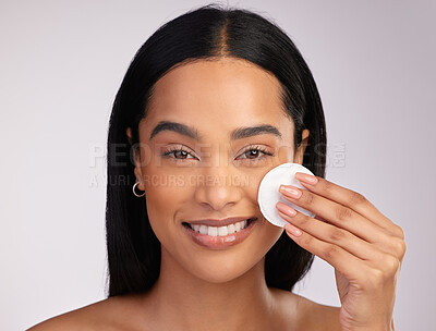Buy stock photo Happy woman, portrait and cotton pad in skincare or makeup removal against a grey studio background. Face of female person wiping product, cosmetics or remove with swab in cleanse or facial treatment