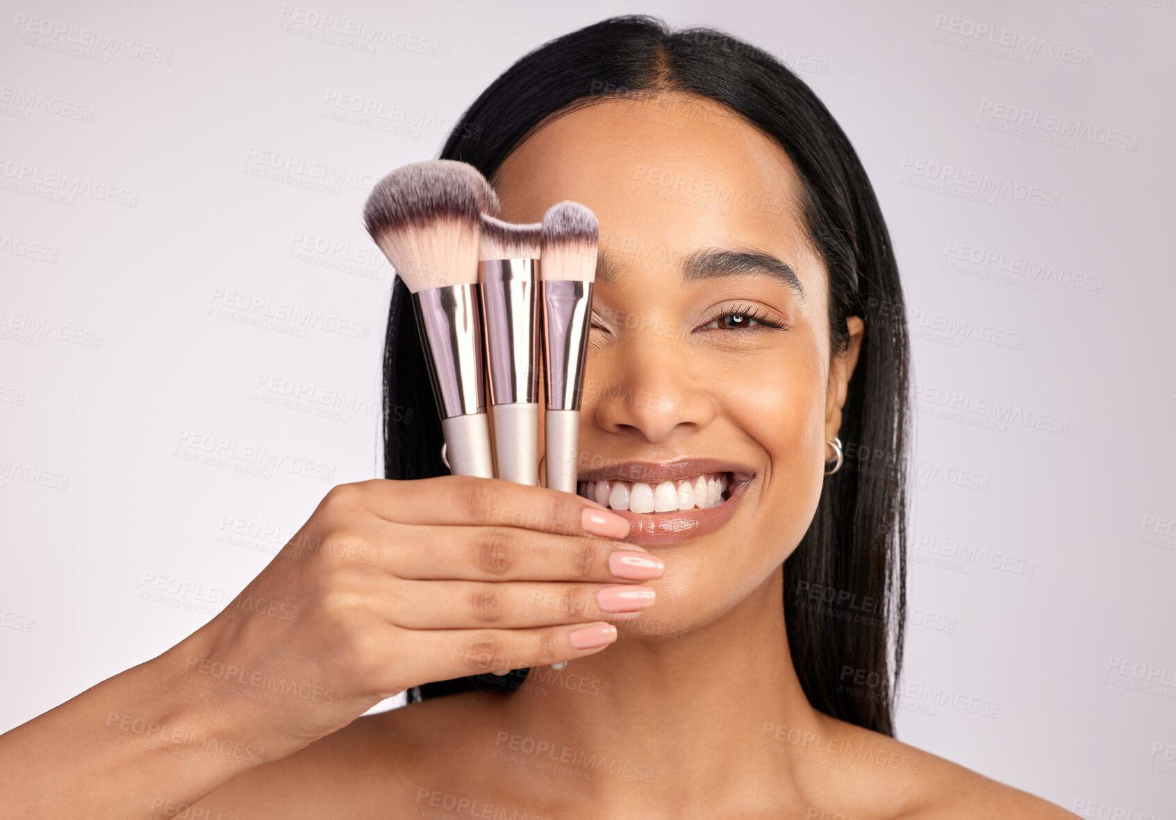 Buy stock photo Happy woman, portrait smile and face with makeup brushes for beauty cosmetics against a grey studio background. Female person cosmetic tools, brush or equipment in self love, care or facial treatment