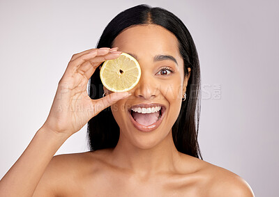 Buy stock photo Happy woman, lemon and face for natural vitamin C, citrus or healthy nutrition against a grey studio background. Portrait of female person with fruit in skincare, collagen or antioxidant for diet