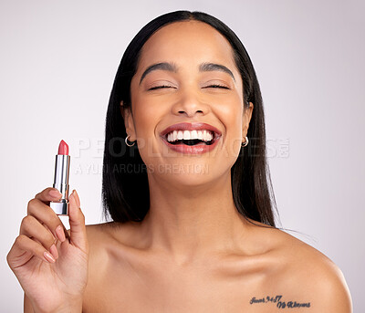 Buy stock photo Cropped portrait of an attractive young woman posing with a lipstick against a pink background