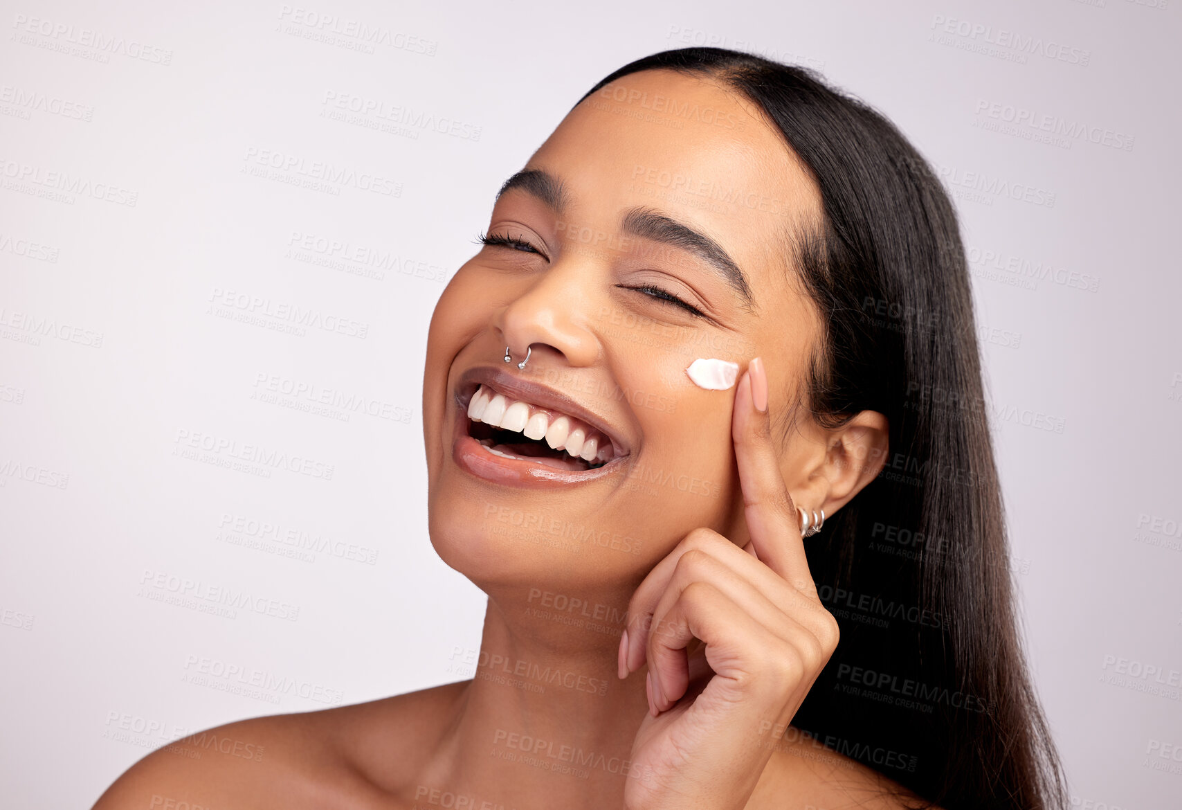 Buy stock photo Happy woman, portrait and skincare cream, product or beauty cosmetics on face against a grey studio background. Female person or model smiling with lotion, creme or moisturizer for facial treatment