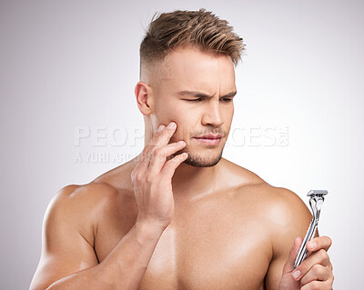 Buy stock photo Doubt, man and razor for shaving face with wellness, skincare and ideas for hygiene in studio. Thinking, guy and product for hair removal and anxiety or stress for sensitive skin by white background