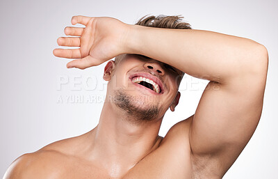 Buy stock photo Studio, man and hand on face for skincare, wellness and cosmetics for beauty with laugh. White background, male model and shy with facial covering, skin glow and feeling fresh while topless with joy