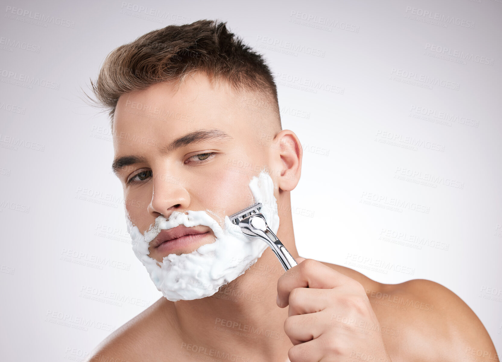 Buy stock photo Man, face and shaving cream with razor in studio, grooming and facial care for beard hair removal with product. Foam, skincare and dermatology or cosmetology, cleaning hygiene and white background