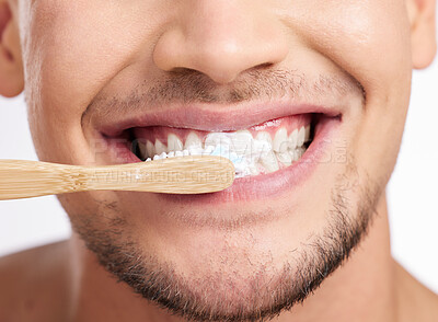 Buy stock photo Studio shot of an unrecognizable man brushing his teeth against a grey background