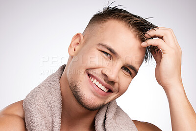 Buy stock photo Hygiene, man and towel in portrait smiling for grooming, cosmetics and wellness in studio white background. Male person, skincare and dermatology cleaning with confidence for bathing, shower or hair