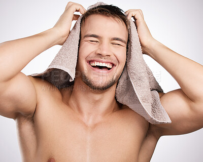 Buy stock photo Studio, towel and happy man with laugh for haircare, collagen and cosmetic after shower with confidence. White background, male model and fabric for freshness, hygiene and routine as treatment