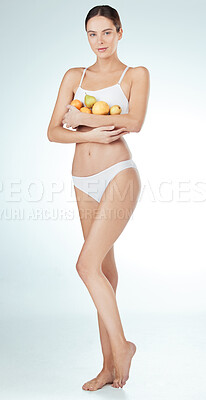 Buy stock photo Woman, fruit and portrait in studio for health, diet and nutrition in underwear on white background. Female nutritionist, food and hands with detox for wellness, self care and vitamins for wellbeing