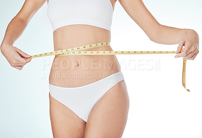 Buy stock photo Woman, underwear and tape measure for weight loss, fitness and healthy diet in white studio background. Female person, progress or stomach check for wellness, body and liposuction or tummy tuck