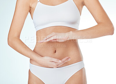 Buy stock photo Woman, abdomen and hands for gut in studio, wellness and lingerie for self care on white background. Female person, stomach and frame belly for digestion, detox and cosmetics treatment or liposuction